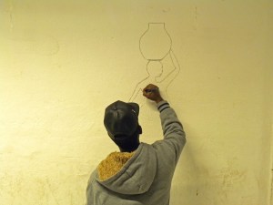 foto-9-un-ragazzo-disegna-a-mano-libera-una-donna-incinta-sulla-parete-del-centro-via-del-frantoio-roma-11-febbraio-2017